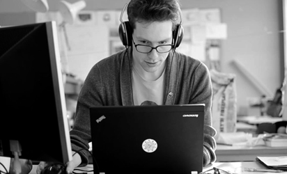 Me sitting behind a desk. Glasses and laptop.